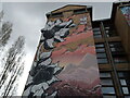 View of street art on the side of an apartment block on Code Street