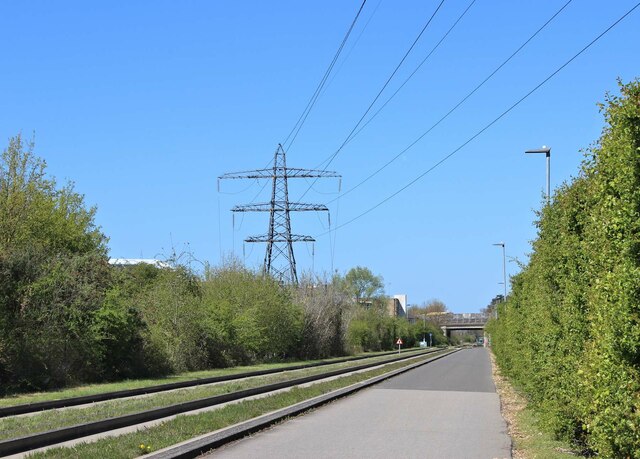 Large electricity pylon alongside guided busway