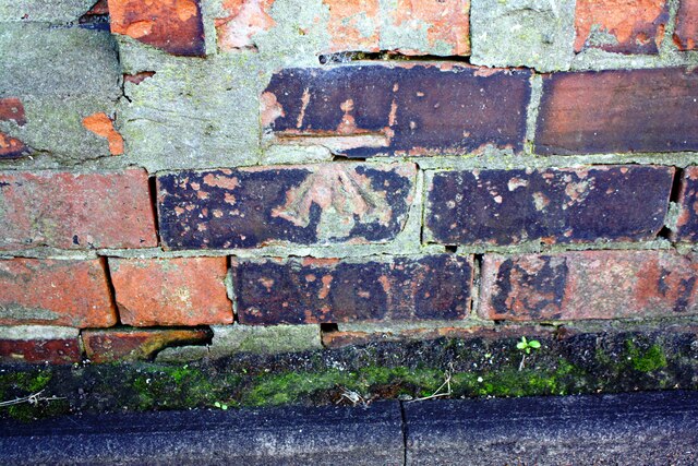 Benchmark on brick wall on south side of Victoria Place