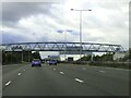 TQ6570 : The A2 heading west under a footbridge by Steve Daniels