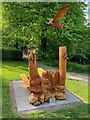 Picnic bench and wood sculpture