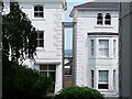 View between two houses on Cintra Park from the communal garden of flats on Belvedere Road