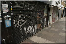 TQ3482 : View of shutter art on the front of Greenlands on Bethnal Green Road by Robert Lamb