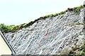 Rockfall netting with man hung out to dry