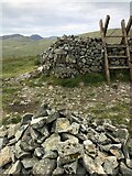 J2625 : Stile at corner of Batt's Wall, summit of Pigeon Rock Mountain by Philip Cornwall