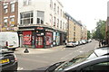 View of street art on the front of StickyWings restaurant on Brick Lane