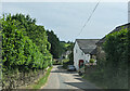 Houses, cars and a public telephone box at Skilgate