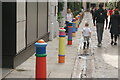 View of brightly painted bollards on Floral Street #3