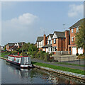 Narrowboat and housing near Stone, Staffordshire