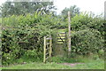 Gated footbridge between grass fields