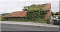 Barns on NE side of A168 at Duncan House