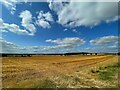 Blue sky above a field of stubble