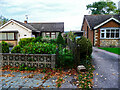 Footpath along the edge of a garden, Thorpe on the Hill