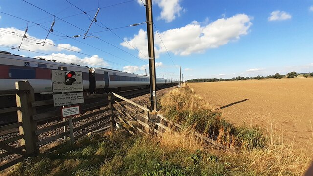 LNER Azuma heading south on ECML at level crossing south of Northallerton