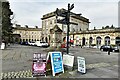 Buxton: Multidirectional sign and a few ads in front of The Crescent