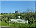 Make do arrangement of direction signs at the junction of Sandbank Road and the B180