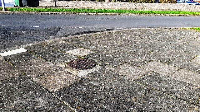 Manhole cover on pavement at junction of  Farbrow Road and High Green Croft
