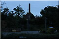 View of the EDME Malt Extract chimney towering above a house in Mistley from the village square