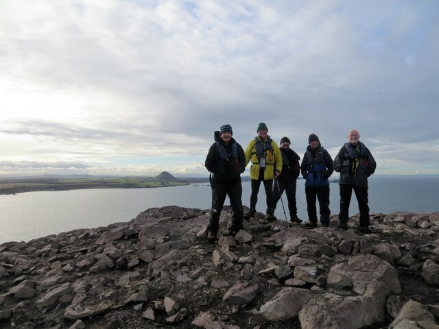 Happy group of walkers on Bass Rock summit