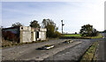 Derelict filling station on north side of A689