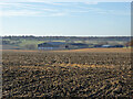 Barns across a ploughed field