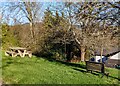 Bench and picnic table on a green, Mynydd-bach, Monmouthshire