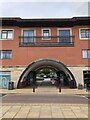 Archway through modern mixed retail and residential development