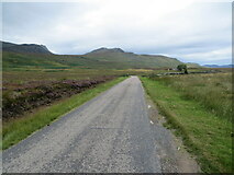 NC6147 : Road (A836) crossing moorland near to Lettermore by Peter Wood