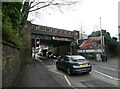 Car passing under a railway bridge in Monument Road