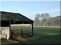 NY9375 : Barn and wintry trees on the Swinburne Castle estate by Oliver Dixon