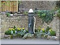 Old water pump and floral display