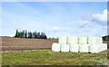 Bales beside earthen field