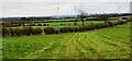 View over fields on SE side of Moor Road towards wind farm