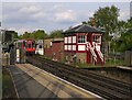 Signal-box at Ruislip station - with Metropolitan Line train approaching