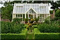 Elsing Hall and Gardens: Greenhouse with peonies within a box surround