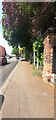 Brick wall bounding covered reservoir on north side of Woodborough Road