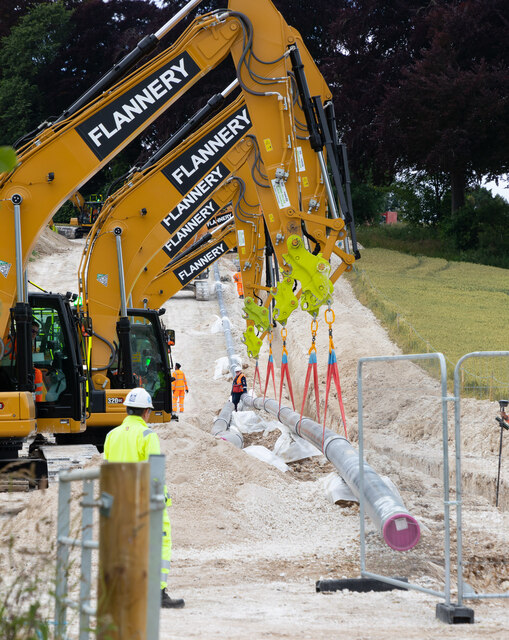 The five excavators begin to lift the pipeline