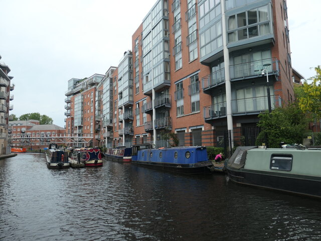 Moored narrowboats below canalside flats