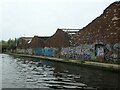 Graffiti tags on derelict factory wall