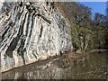 Overhanging crag above the muddy path