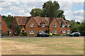 Houses seen across green at Woolstone