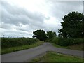 Road junction and road to Perry Hill Farm