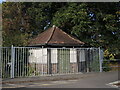 An octagonal house behind bars