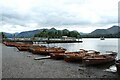NY2622 : Rowing boats on the shore of Derwent Water by Graham Robson