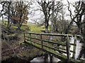 Footbridge with road rising towards Cushat Leazes