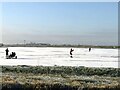 TL2799 : Skating on a frozen field, Whittlesey Wash - The Nene Washes by Richard Humphrey