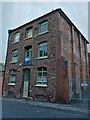 Stone building with brick buttresses, Smythen Street, Exeter