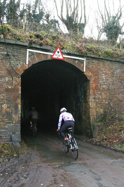 Cyclists climbing through the aqueduct over Shrigley Road