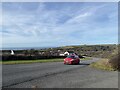 Red car on road from Broad Haven