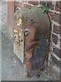 Damaged stone and benchmark by 62 Hough Green, Chester